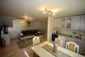 a kitchen and living room with a couch and a table at Apartment Vihor in Zlatibor