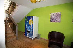 a room with a vending machine and a staircase at Hotel Sunny Side Up in Dauchingen