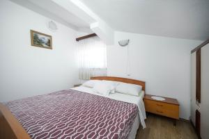 Postel nebo postele na pokoji v ubytování Apartmani Križanović
