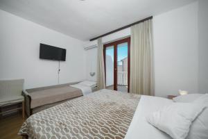 Postel nebo postele na pokoji v ubytování Apartmani Križanović