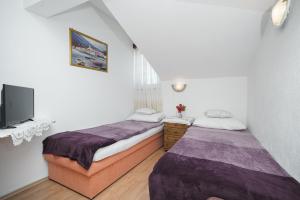 Postel nebo postele na pokoji v ubytování Apartmani Križanović