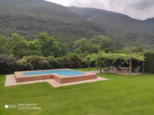 a swimming pool in a yard with mountains in the background at Agriturismo Revena in Belluno Veronese