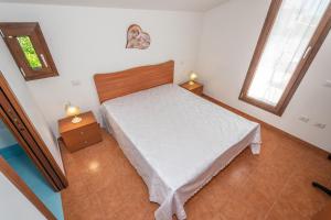 a small bedroom with a bed and two night stands at Villa Pietro in Lascari