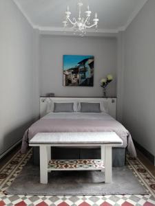 a bedroom with a bed and a chandelier at Apartamento Torreón de la Bombardera in Teruel