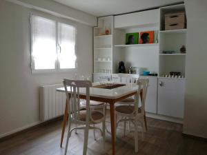 a kitchen with a table and chairs in a room at Apartamento Torreón de la Bombardera in Teruel