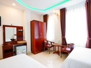 Postel nebo postele na pokoji v ubytování Dalat Venus Hotel