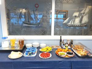a blue table with plates of food on it at Glen Orchy House in Lerwick
