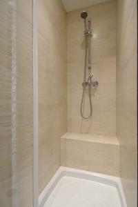a bathroom with a shower with a tub at HolidaysInParis - Republique in Paris +25 photos