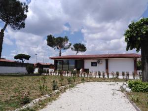 a house with a fence in front of a yard at Villa Ivana in Rome