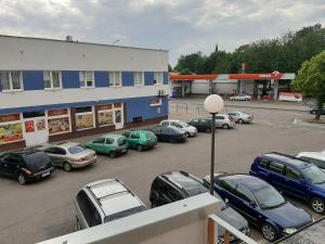 a group of cars parked in a parking lot at Apartament Ustka in Ustka