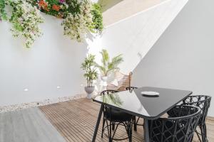 a balcony with a table and chairs and plants at Casa Boma Lisboa - Architect Apartment with Private Terrace - Alcantara III in Lisbon