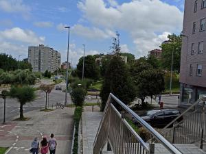 a group of people walking down a stairs in a city at Hostal La Torre in Santander