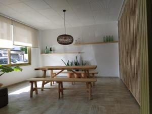 une salle à manger avec une table et un banc en bois dans l'établissement Hostal Residencia Nicolau, à Sant Antoni de Portmany