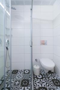 a white bathroom with a shower and a toilet at Sezin Apart in Marmaris +11 photos
