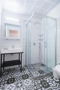a bathroom with a glass shower and a sink at Sezin Apart in Marmaris