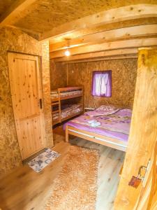 a small room with two beds and a door at Camp Sutjeska in Tjentište