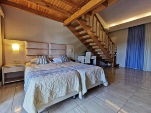 a bedroom with a large bed and a staircase at Sidari Waterpark in Sidari