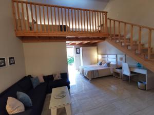 a living room with a bed and a staircase at Sidari Waterpark in Sidari