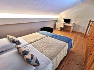 a bedroom with two beds and a desk with a computer at Sidari Waterpark in Sidari