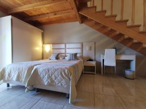 a bedroom with a bed and a desk and a staircase at Sidari Waterpark in Sidari