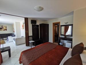 a bedroom with a bed and a living room at Sidari Waterpark in Sidari