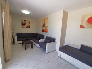 a living room with a couch and a bed at Sidari Waterpark in Sidari
