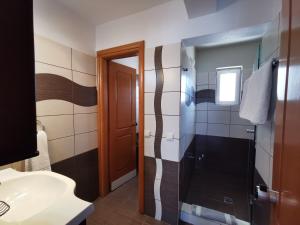 a bathroom with a shower and a sink at Sidari Waterpark in Sidari