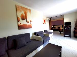a living room with two couches and a painting on the wall at Sidari Waterpark in Sidari