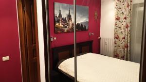 a bedroom with a bed and a picture of a castle at GREEN VIEW in Sinaia