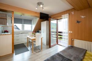 a kitchen and dining room with a table and a refrigerator at Apartment Kikelj in Bohinj