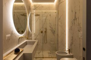 a bathroom with a sink, toilet and bathtub at Palazzo BN Luxury Suites in Lecce