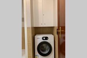 a washer and dryer in a small room at Apartamento primera línea de Mar Enjoy the view in Blanes