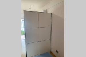 a large white cabinet in a room with a window at Apartamento primera línea de Mar Enjoy the view in Blanes