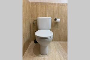 a bathroom with a white toilet in a room at Apartamento primera línea de Mar Enjoy the view in Blanes