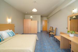 a hotel room with a bed and a desk at Kohylia by La Scala Beach in Limenas