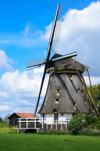 a windmill with a roof on top of it at Mondriaanmolen, a real Windmill close to Amsterdam in Abcoude