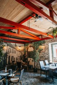 a restaurant with tables and chairs and a brick wall at Dooscht Gästehaus Reichshof in Kröv