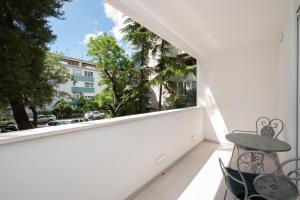 a balcony with a table and chairs and a window at Lions apartment in Split