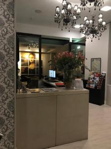 a store with a counter with flowers on it at Hotel Pilar Plaza in Zaragoza