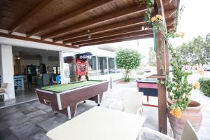 a patio with a pool table and a store at DebbieXenia Hotel Apartments in Protaras