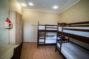 a room with two bunk beds and a table at HOLLYWOOD in Poltava