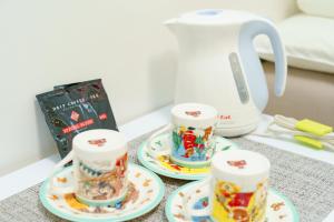 a table with three cups and a tea kettle at Osaka Yeon House in Osaka