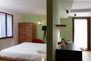 a bedroom with a bed and a desk and window at A3Passi in Ancona
