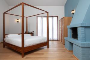 una camera con letto a baldacchino e camino di A3Passi ad Ancona