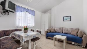 a living room with a couch and a table at Rona Apartment Zdravko in Barbariga