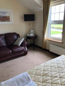 a living room with a couch and a window at Seashore B&B in Ballybunion