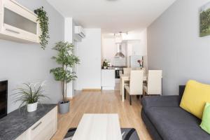 a living room filled with furniture and a table at Maple Tree Budget Apartments in Budapest