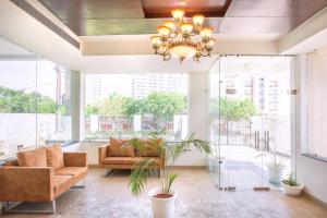 a living room with a chandelier and a couch at The Vrindwoods in Vrindāvan