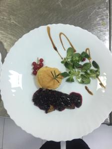 a white plate with fruits and vegetables on it at HOSTEL CPPI Vest in Buşteni