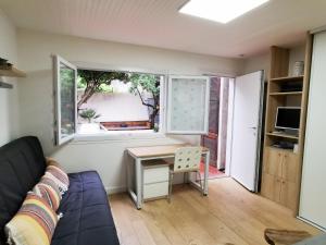 a living room with a desk and a window at Nice - Charming little house with terrace in Nice